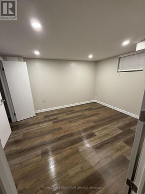 Hamilton (Mohawk) apartment for rent - A room with wooden flooring and white walls.