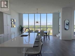 Niagara Falls (Oldfield) condo for rent - A modern kitchen with a large island and a view of the outdoors.
