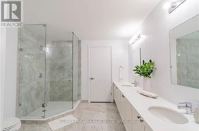 Niagara Falls (Oldfield) condo for rent - A bathroom with a marble wall and a glass shower stall.
