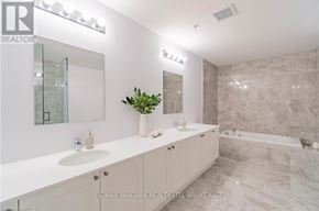 Niagara Falls (Oldfield) condo for rent - A bathroom with a marble wall and a plant on the counter.