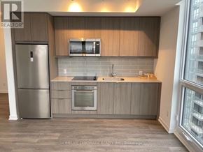 Toronto (Henry Farm) condo for rent - A kitchen with a refrigerator, microwave, oven, and sink.