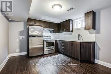 Oshawa (Donevan) apartment for rent - A modern kitchen with dark wood floors and stainless steel appliances.