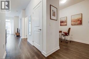 Beamsville condo for rent - A hallway with a chair and a painting on the wall.