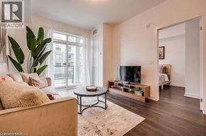 Beamsville condo for rent - A living room with a couch, coffee table, and a television.