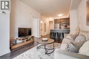 Beamsville condo for rent - A living room with a white couch and a television.