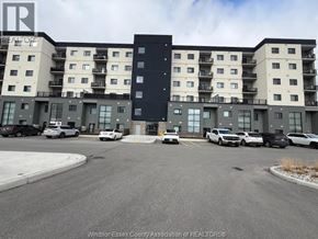 Lasalle condo for rent - A large apartment complex with a parking lot in front.