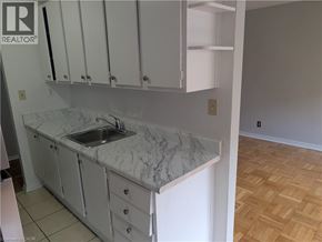 Burlington apartment for rent - A kitchen with white cabinets and a marble countertop.