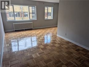 Burlington apartment for rent - A room with wooden flooring and a window with a radiator beneath it.