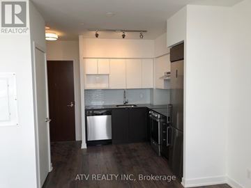 Toronto (Englemount-Lawrence) condo for rent - A kitchen with white cabinets and black appliances.