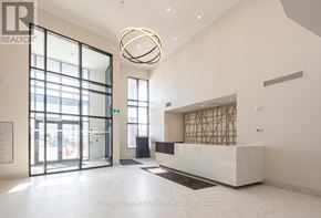 Clarington (Bowmanville) condo for rent - A reception area with a white marble counter and a large circular light fixture.