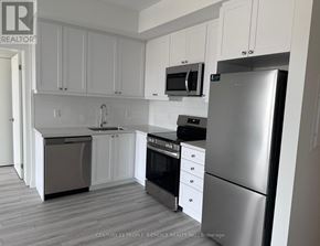 Clarington (Bowmanville) condo for rent - A kitchen with white cabinets and stainless steel appliances.