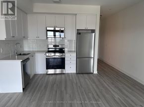 Clarington (Bowmanville) condo for rent - A kitchen with white cabinets and stainless steel appliances.