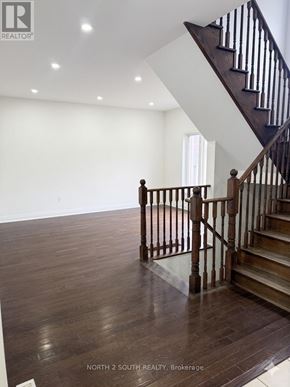 Innisfil (Alcona) apartment for rent - A wooden staircase with a white wall in the background.