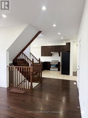 Innisfil (Alcona) apartment for rent - A wood staircase with a metal railing leads to a second floor.