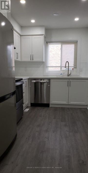 Toronto (West Humber-Clairville) townhouse for rent - A modern kitchen with a dishwasher and a refrigerator.