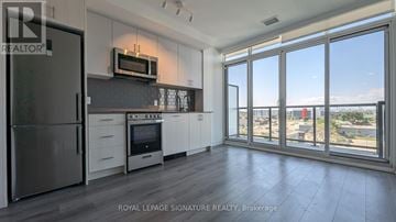 Toronto (Islington-City Centre West) condo for rent - A kitchen with a refrigerator, oven, and microwave.