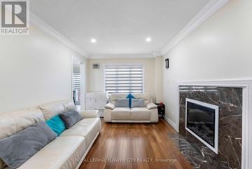 Brampton (Northwood Park) apartment for rent - A living room with a white couch and a fireplace.