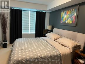 Toronto (Willowridge-Martingrove-Richview) condo for rent - A bedroom with a large bed and a painting on the wall.