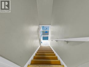 Windsor apartment for rent - A staircase with wooden steps leading to a blue pool.
