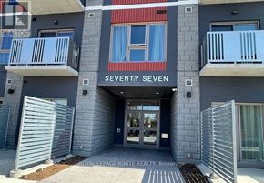 Hamilton (Ainslie Wood) condo for rent - The entrance to a building named Seventy Seven with a glass door and a metal gate.
