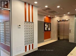 Hamilton (Ainslie Wood) condo for rent - A hallway with a black carpet and a wall of mailboxes.