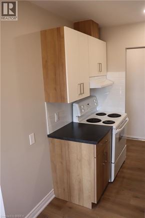Brantford apartment for rent - A kitchen with a stove and cabinets.