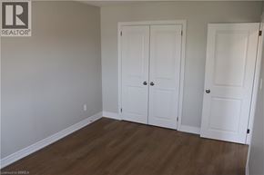 Brantford apartment for rent - A room with two white doors and a wooden floor.