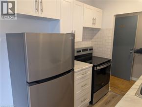 Burlington apartment for rent - A kitchen with a stainless steel refrigerator and white cabinets.