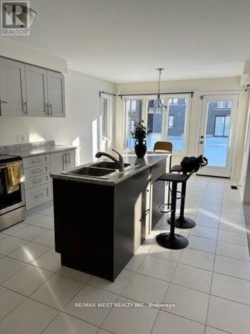 New Tecumseth (Alliston) apartment for rent - A kitchen with a black island and white cabinets.