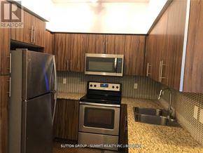 Oakville (Co Central) condo for rent - A kitchen with a refrigerator, oven, microwave, and sink.