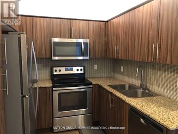 Oakville (Co Central) condo for rent - A kitchen with wooden cabinets and stainless steel appliances.