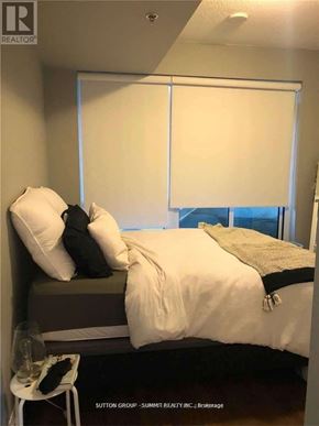Oakville (Co Central) condo for rent - A bedroom with a bed, pillows, and a chair.