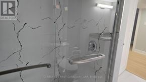 London East (East D) apartment for rent - A bathroom with a marble wall and a shower.