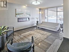 Mississauga (Applewood) condo for rent - A living room with a grey couch and a rug.