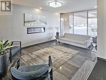 Mississauga (Applewood) condo for rent - A living room with a grey couch and a rug.