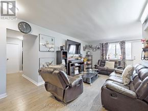 Mississauga (Applewood) condo for rent - A living room with a brown leather couch and a glass coffee table.