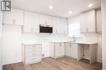 Toronto (Islington-City Centre West) duplex for rent - A kitchen with white cabinets and a microwave above the counter.