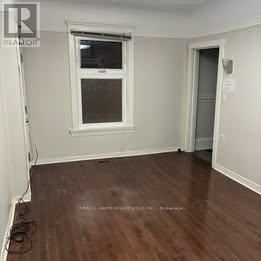 Toronto (Trinity-Bellwoods) apartment for rent - A room with a window and wooden flooring.