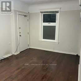 Toronto (Trinity-Bellwoods) apartment for rent - A room with a white door and a window with a white frame.