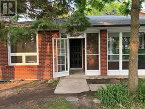 Toronto (West Hill) apartment for rent - A red brick house with a white door and a tree in front.