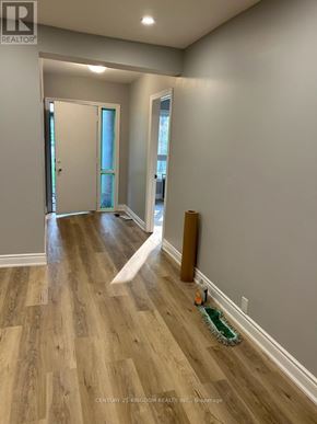 Toronto (West Hill) apartment for rent - A room with wooden flooring and a green rug on the floor.