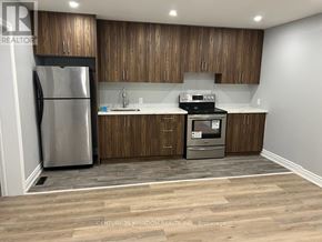 Toronto (West Hill) apartment for rent - A kitchen with wooden cabinets and a stainless steel refrigerator.