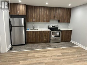 Toronto (West Hill) apartment for rent - A kitchen with wooden cabinets and a stainless steel refrigerator.