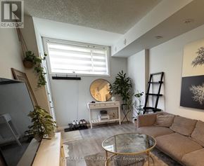 Burlington (Lasalle) townhouse for rent - A living room with a couch, coffee table, and plants.