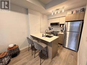 Burlington (Lasalle) townhouse for rent - A kitchen with a refrigerator, sink, and stove.