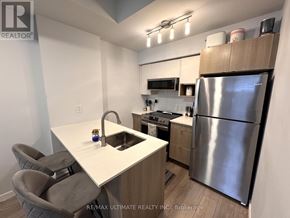 Burlington (Lasalle) townhouse for rent - A kitchen with a white counter top and a stainless steel refrigerator.