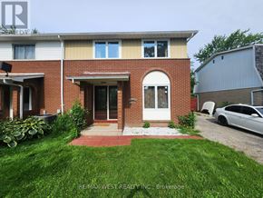 Windsor apartment for rent - A house with a red brick facade and a white door is for sale.