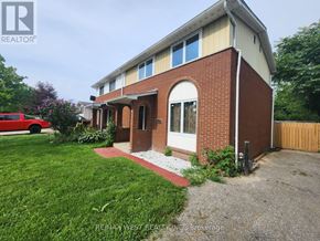 Windsor apartment for rent - A house with a red car parked in front.