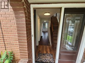 Windsor apartment for rent - A hallway with a wooden floor and a staircase.