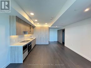 Toronto (Bayview Village) condo for rent - A modern kitchen with wooden cabinets and a countertop.
